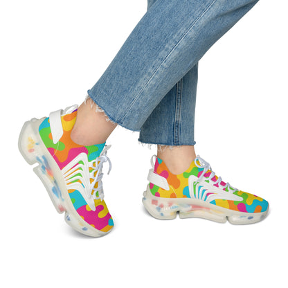 Colorful sneakers with a pattern worn by a person in jeans on a white background