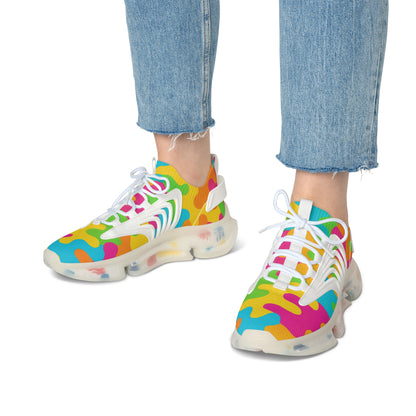 Colorful sneakers with a white sole worn with blue jeans on a white background