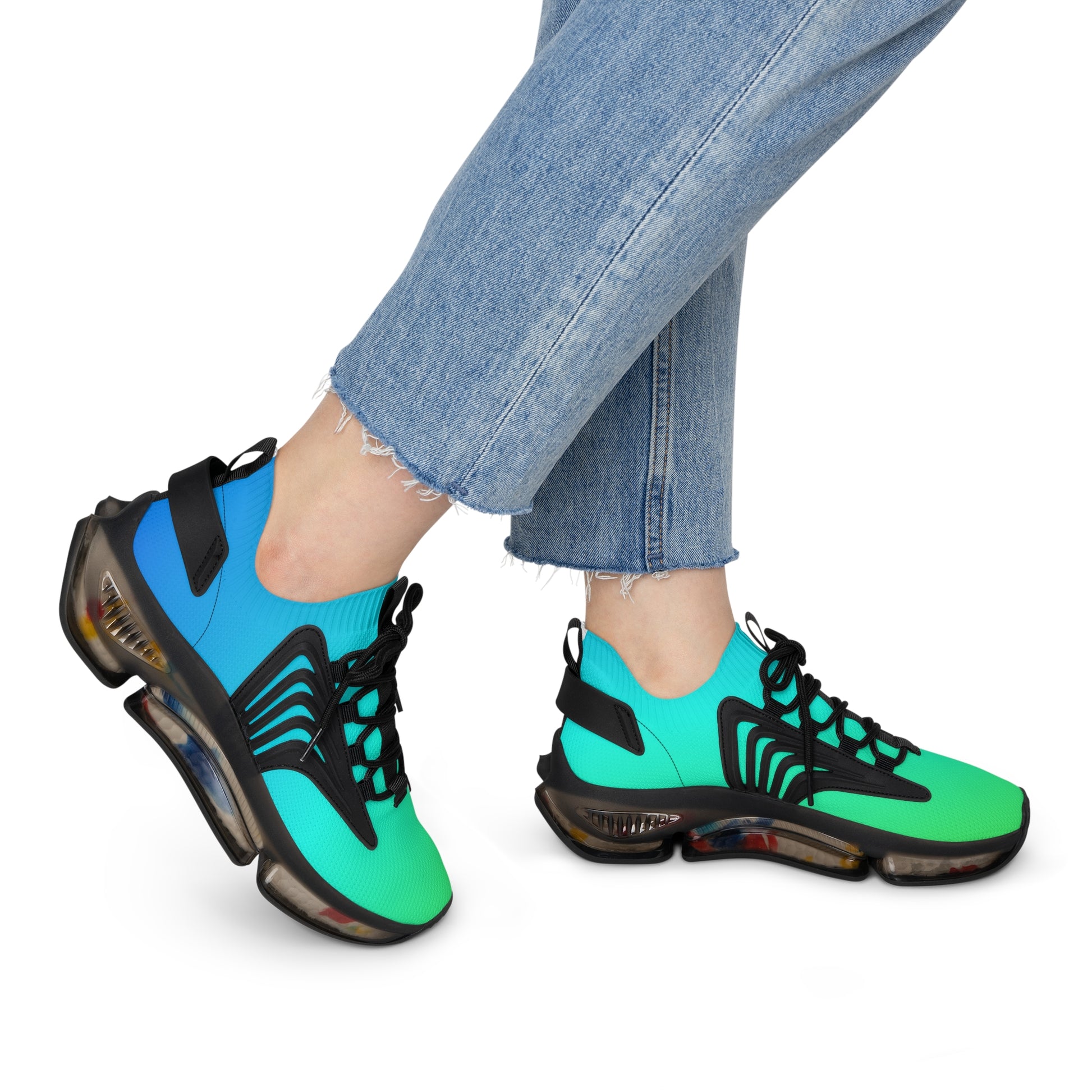 Neon green and blue sneakers worn with light blue jeans on a white background