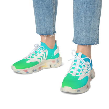 Green and blue sneakers with white laces worn with blue jeans on a white background