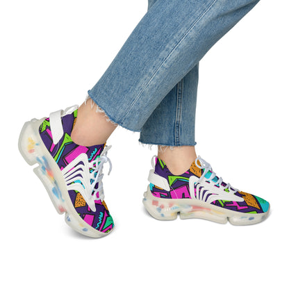 Colorful sneakers with abstract patterns worn with blue jeans on a white background