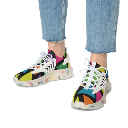 Colorful sneakers with abstract patterns worn with blue jeans on a white background