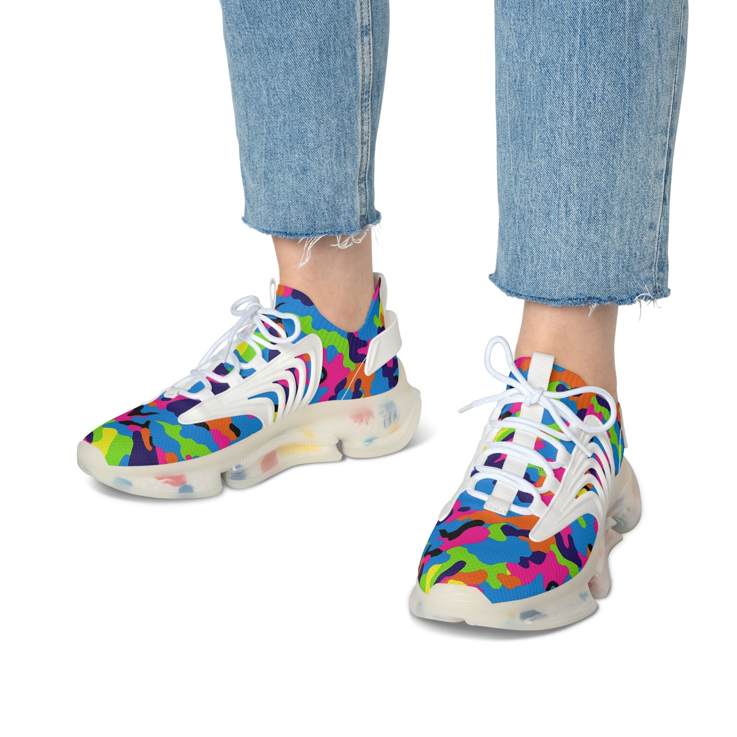 Colorful sneakers with abstract pattern worn with blue jeans on a white background