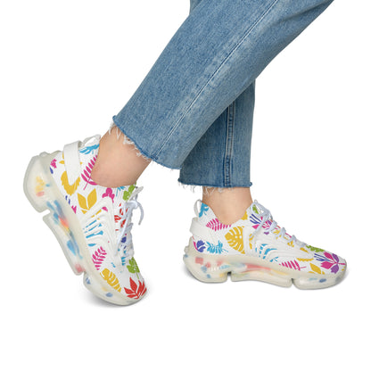 Colorful floral-patterned sneakers worn with blue jeans on a white background