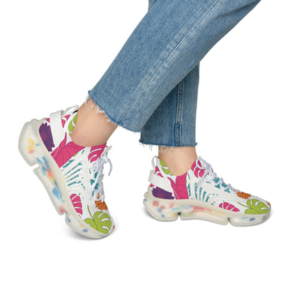 Colorful floral-patterned sneakers worn with blue jeans on a white background