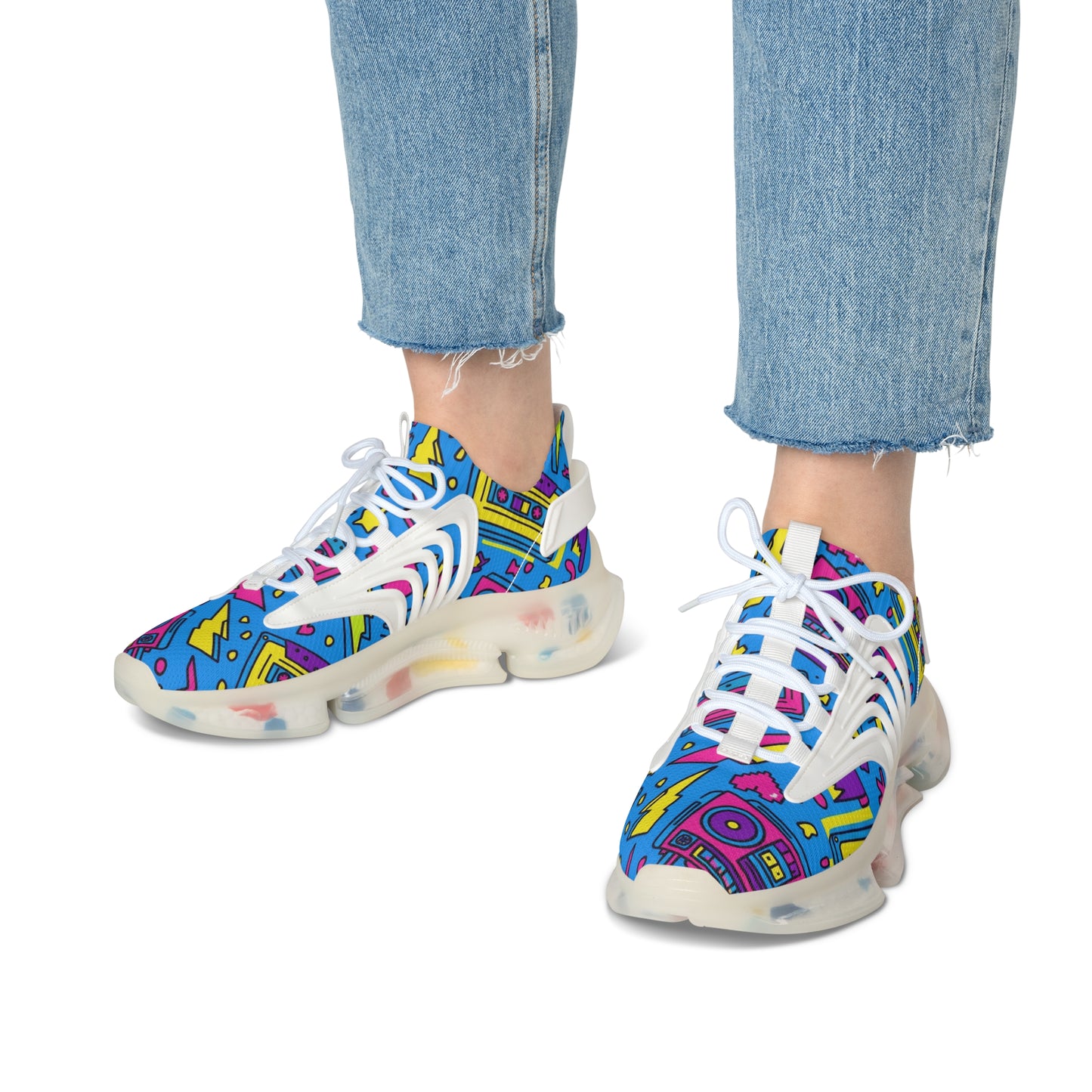 Colorful sneakers with abstract pattern worn with blue jeans on a white background